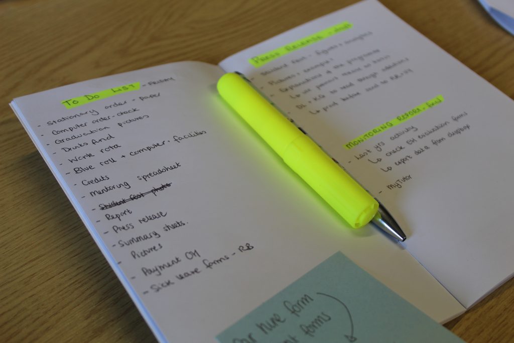 A notebook with office actions, some highlighted in yellow